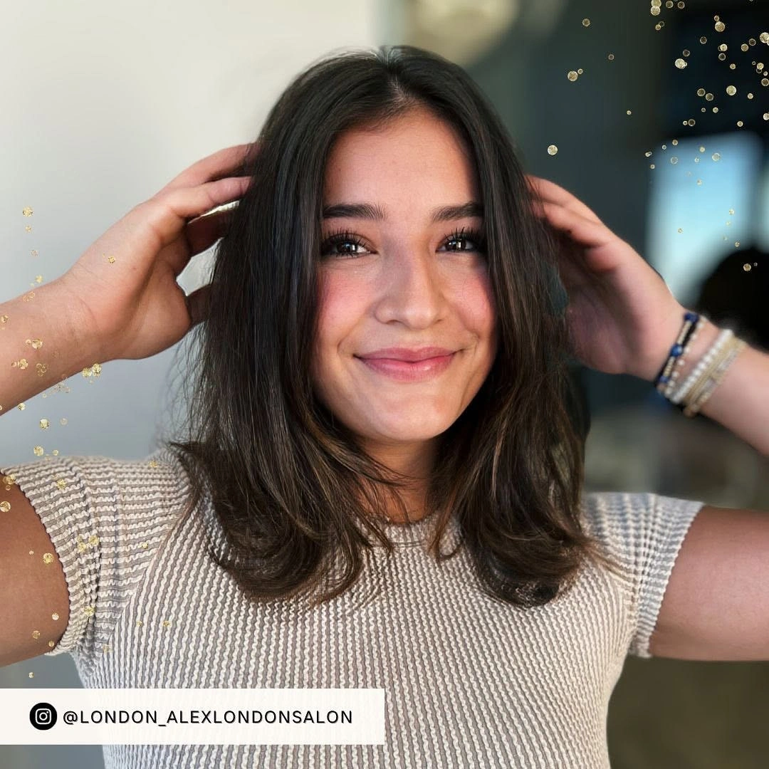 Short ash brown bob with center part and softly curved ends