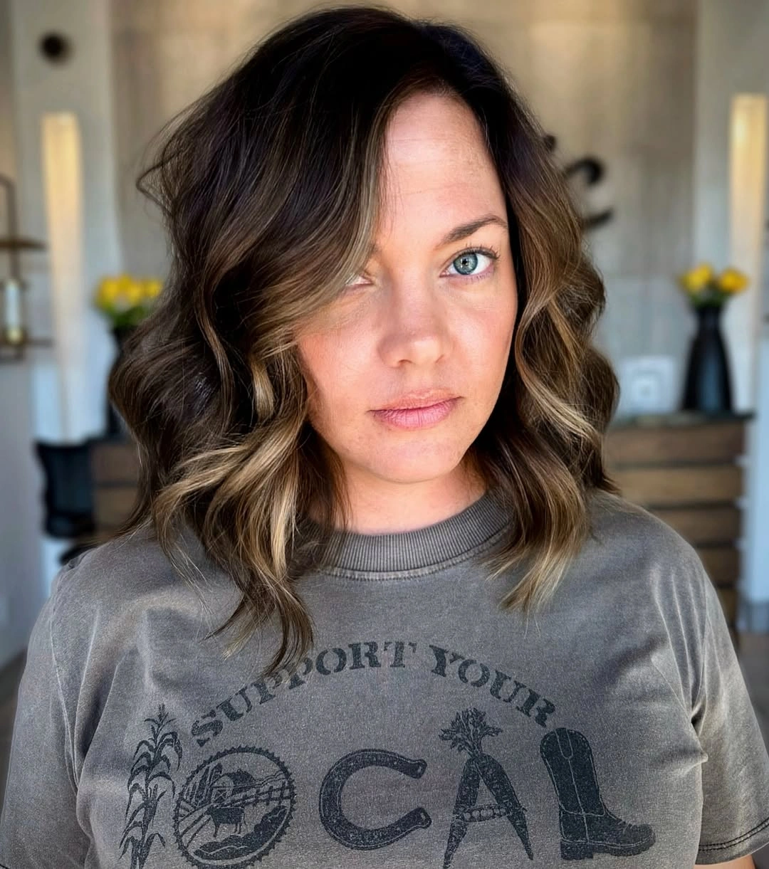 Shoulder length brunette hair with light caramel face framing