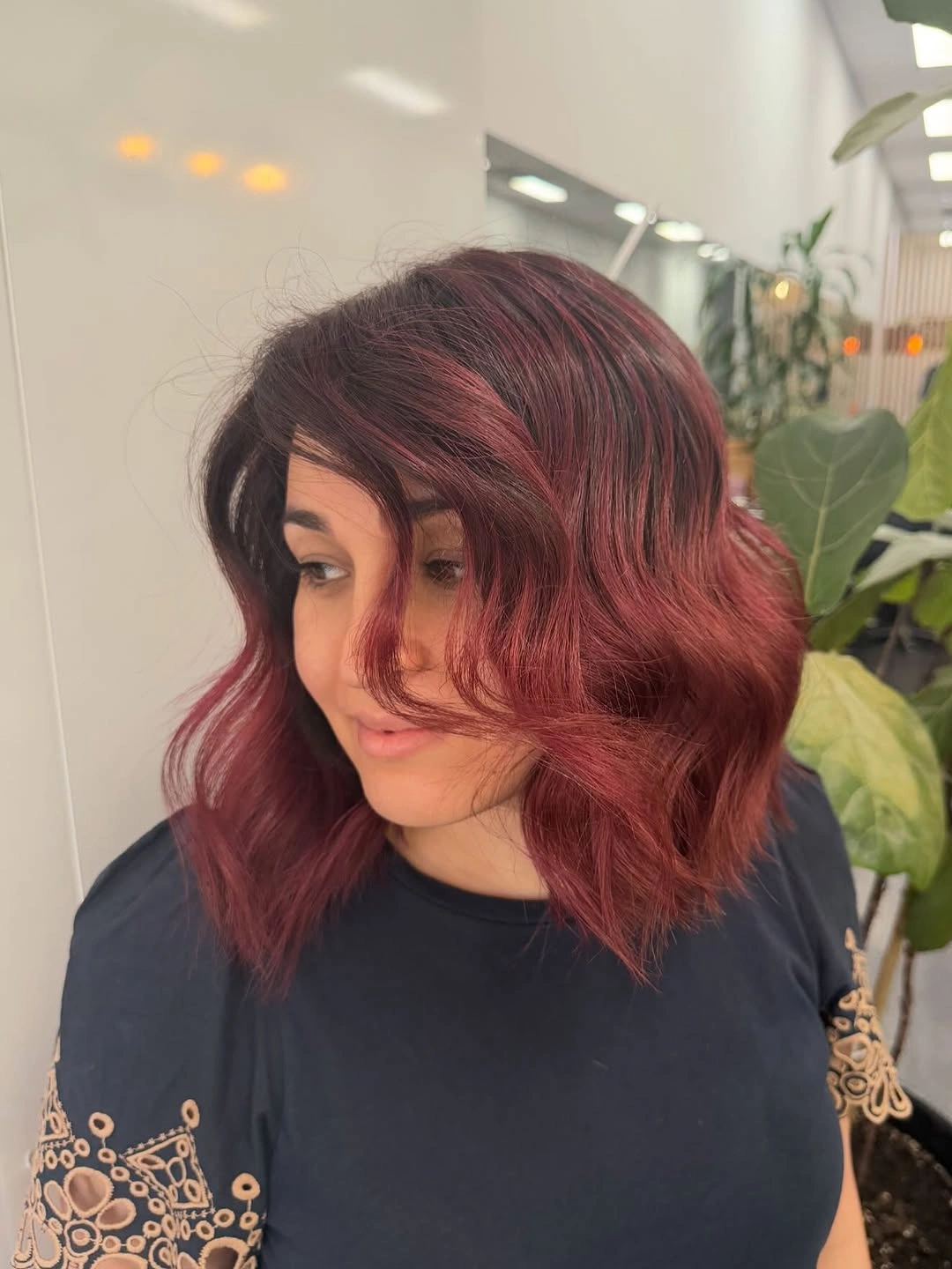 Short wavy rose brown bob with muted berry reflections