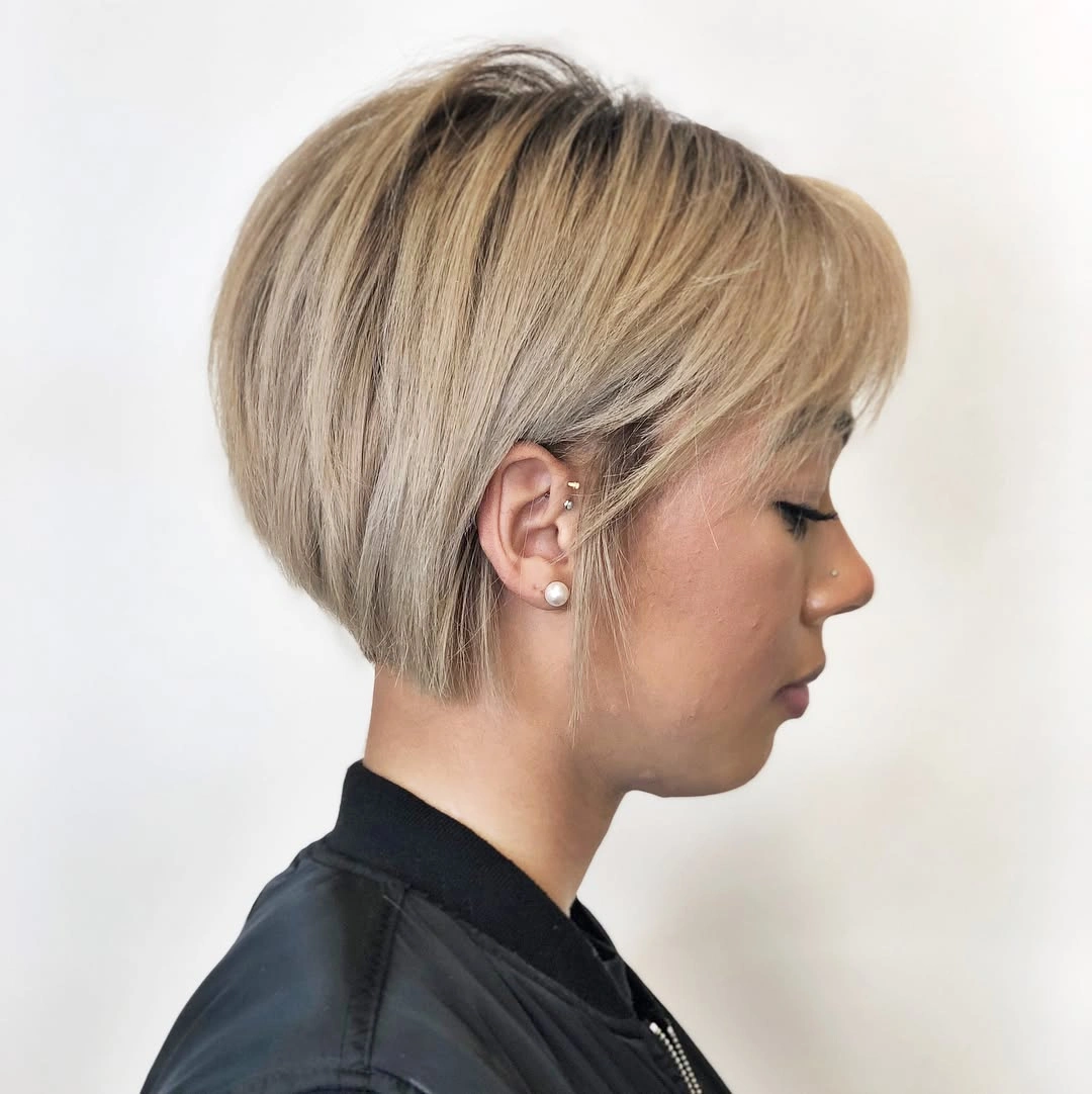 Short cool blonde pixie bob with rounded volume and side profile