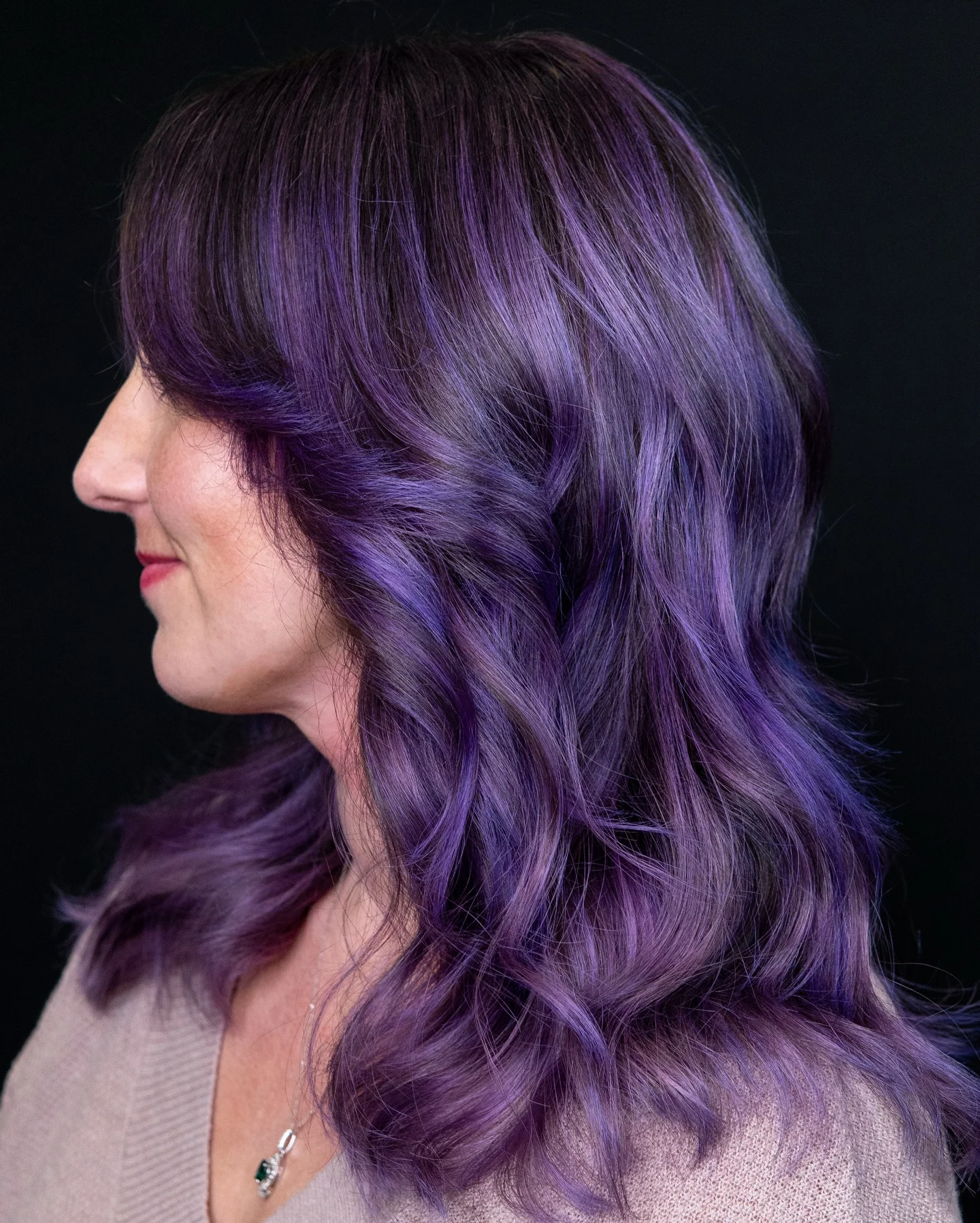 Medium long wavy violet hair with darker roots and lavender dimension