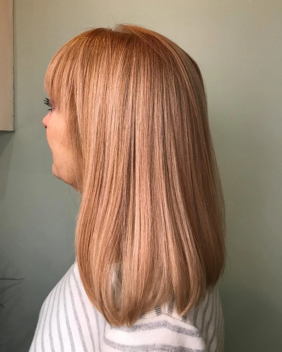 Straight medium long warm copper auburn hair in side profile