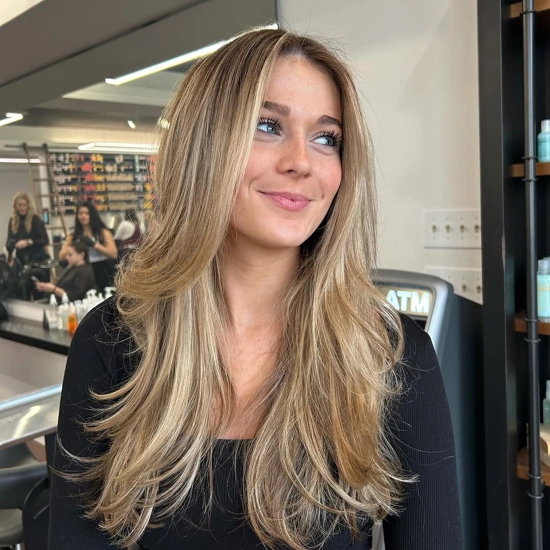 Long beige blonde hair with sweeping face framing layers