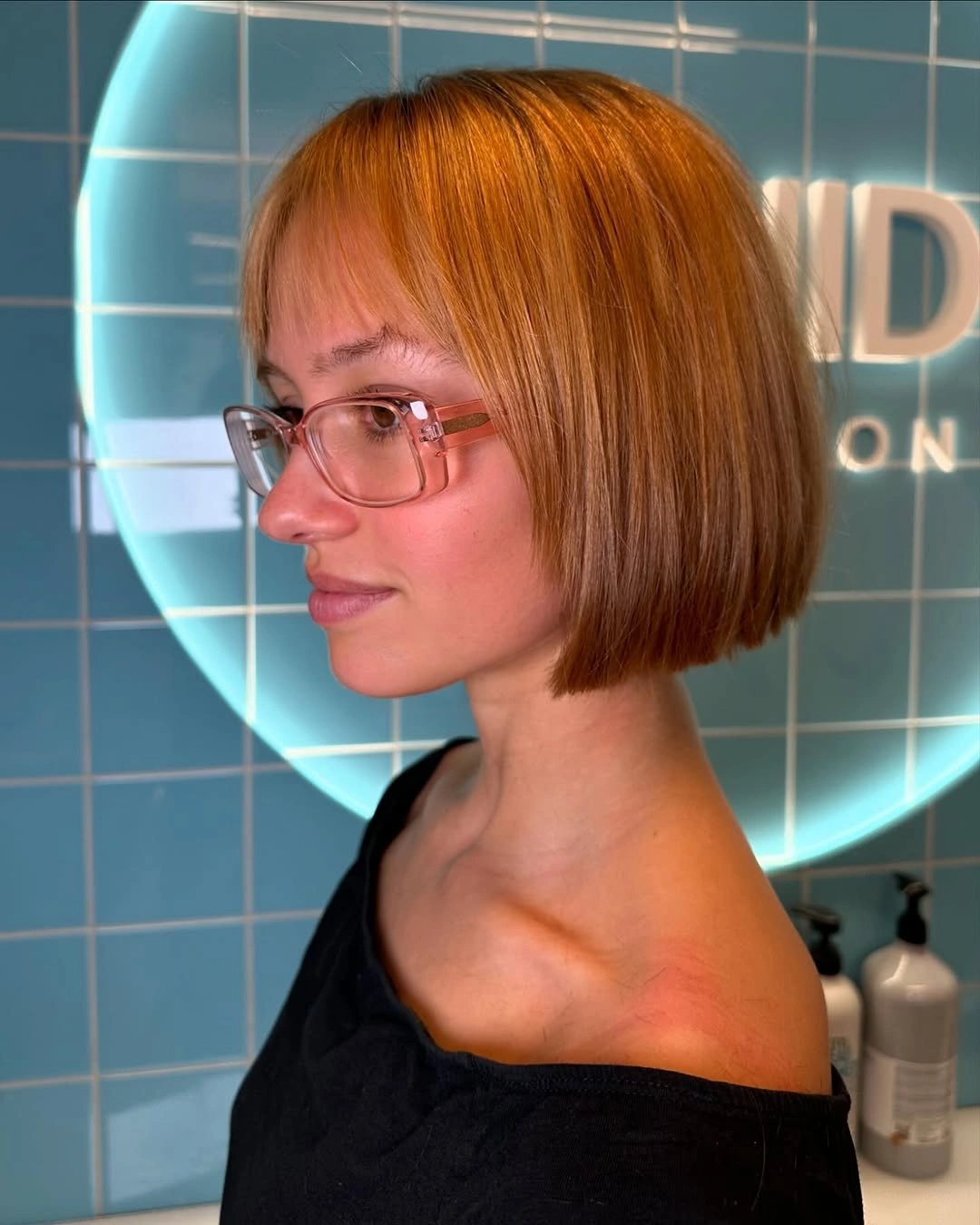 Short copper bob haircut with smooth straight ends and side profile