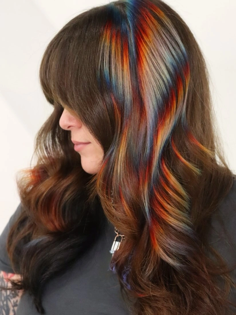 Dark wavy hair with vivid blue and orange accent ribbons