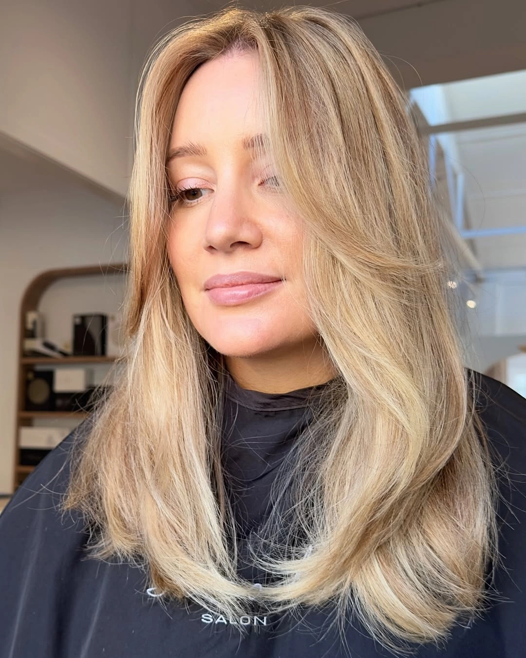 Long soft beige blonde hair with center part and curtain layers