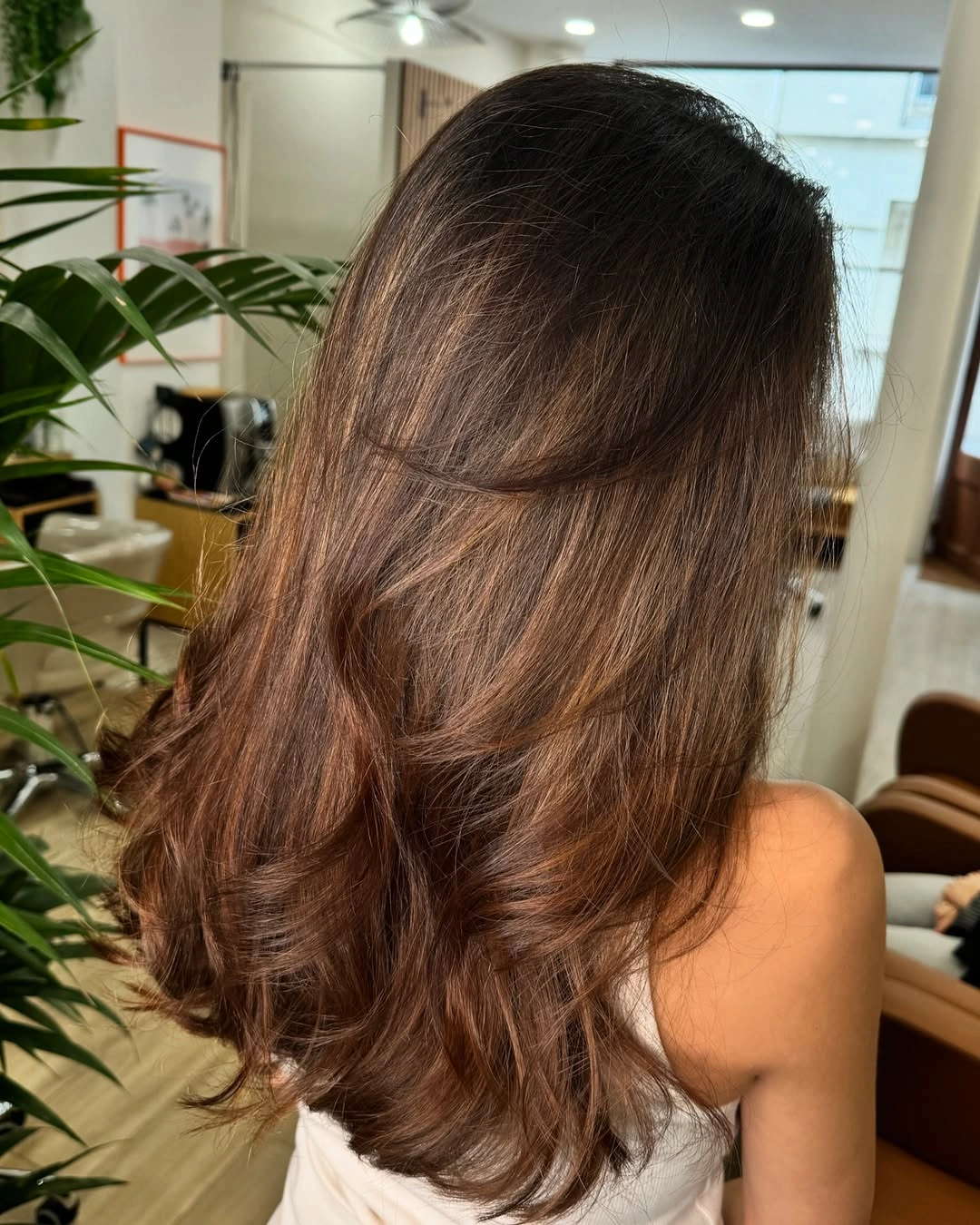 Medium length warm brunette waves with softly turned ends