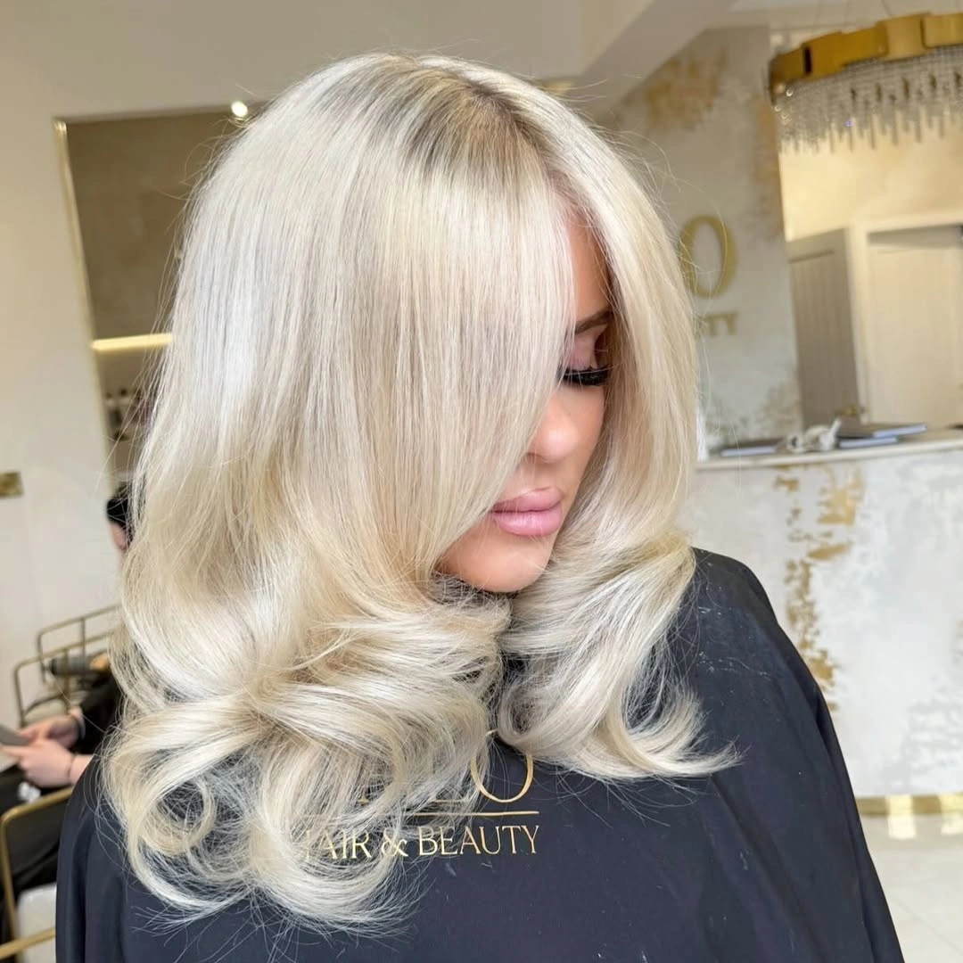 Medium-length creamy blonde with bright front and curled ends