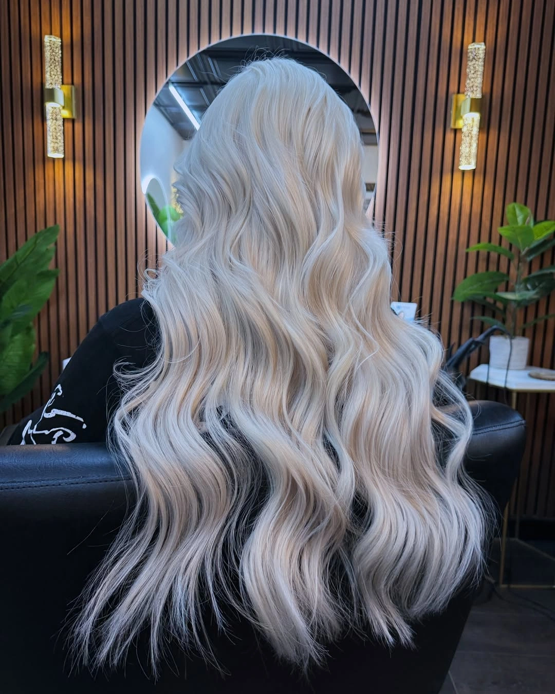 Long wavy platinum-cream blonde hair with slight root depth