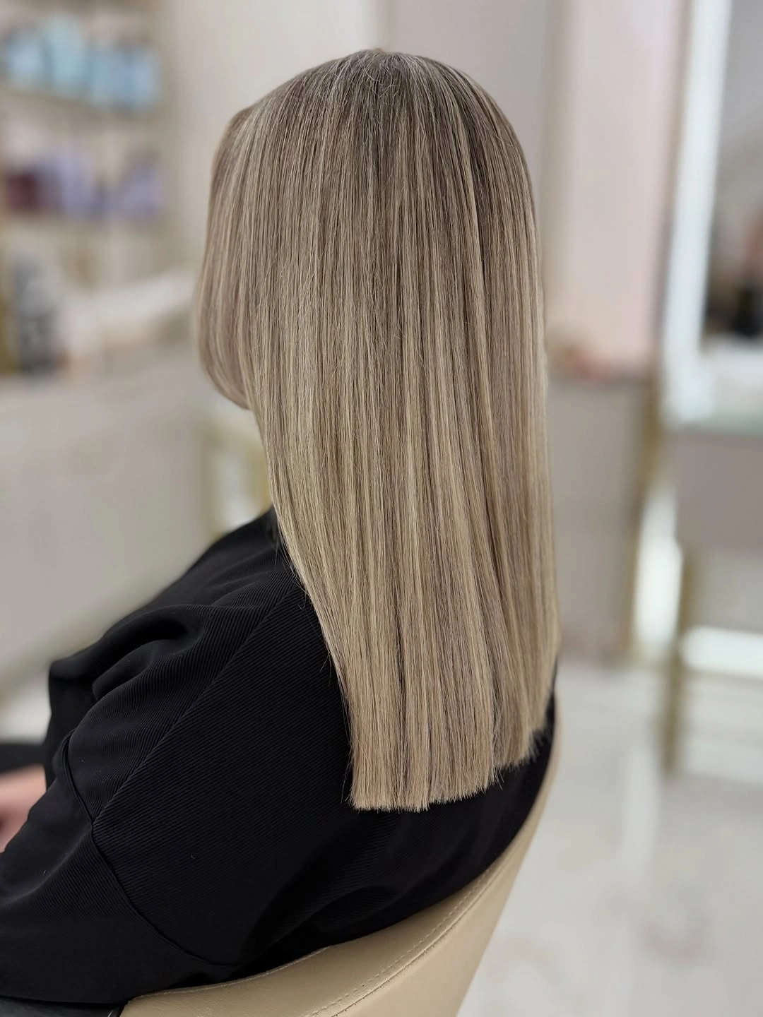 Long cool ash blonde hair with deeper gray-brown roots