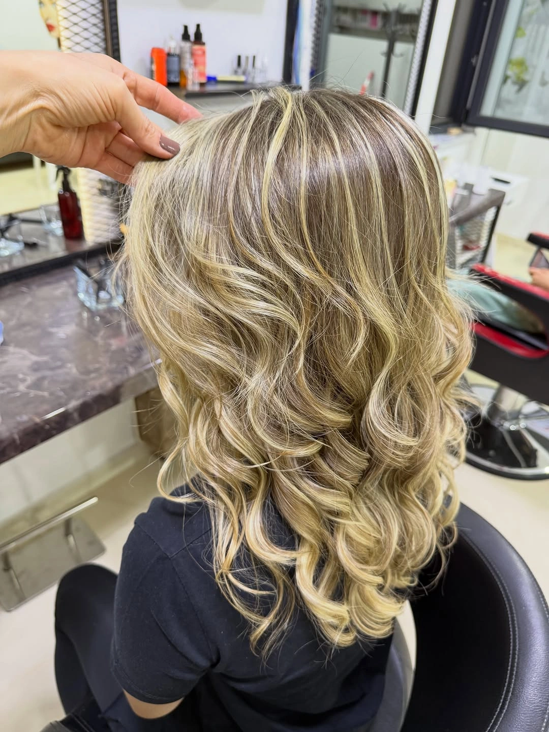Curled dark blonde hair with broad golden and cream ribbons