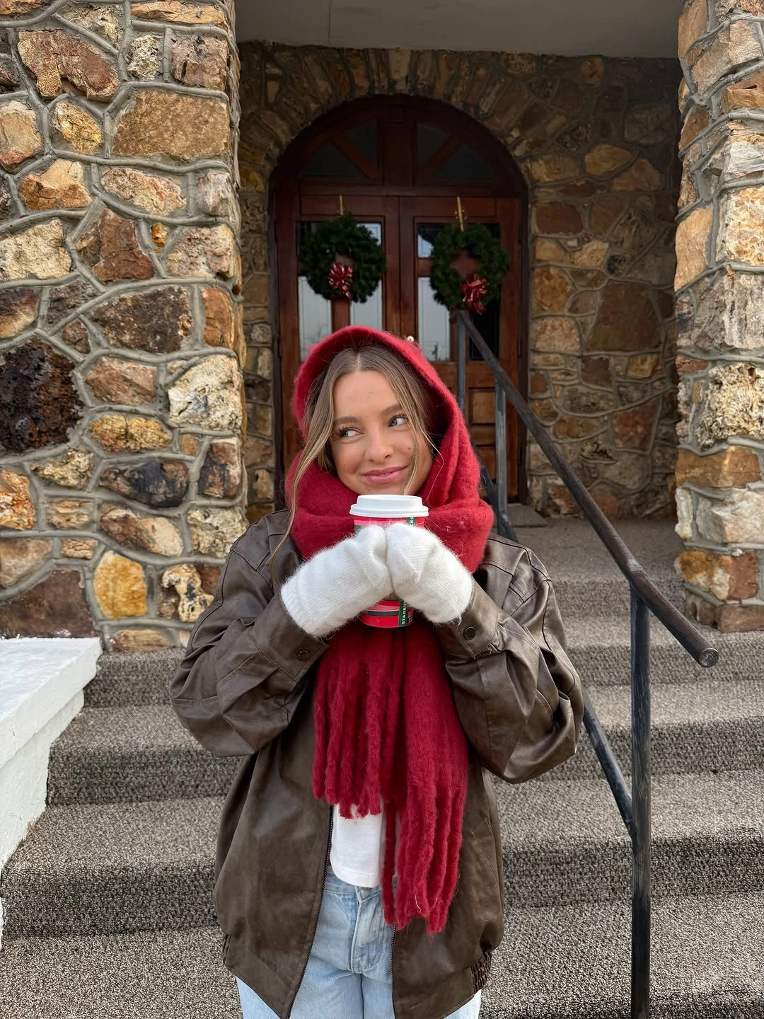 Red scarf with brown jacket, white mittens and light jeans