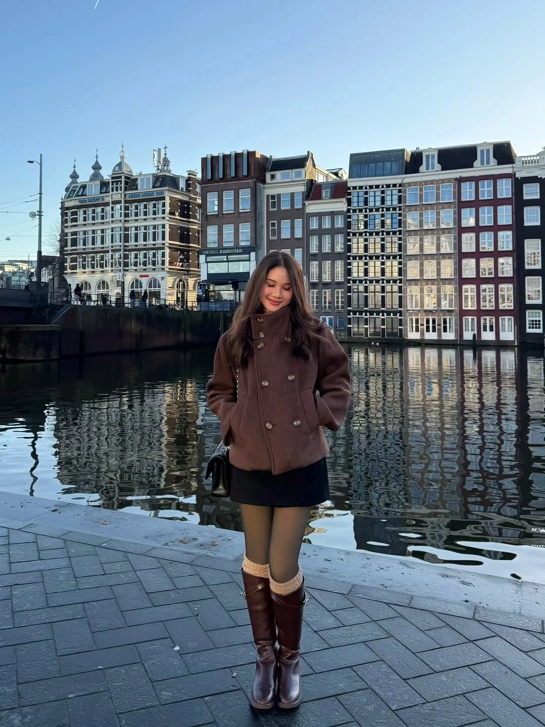 Brown short coat with sheer tights and tall cuffed boots