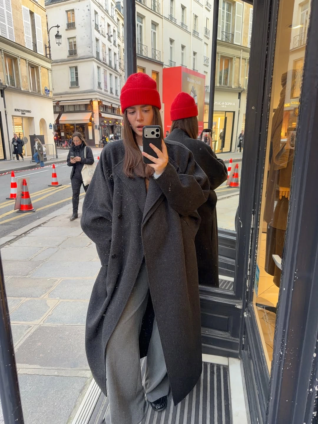 Oversized gray coat with wide trousers and red beanie