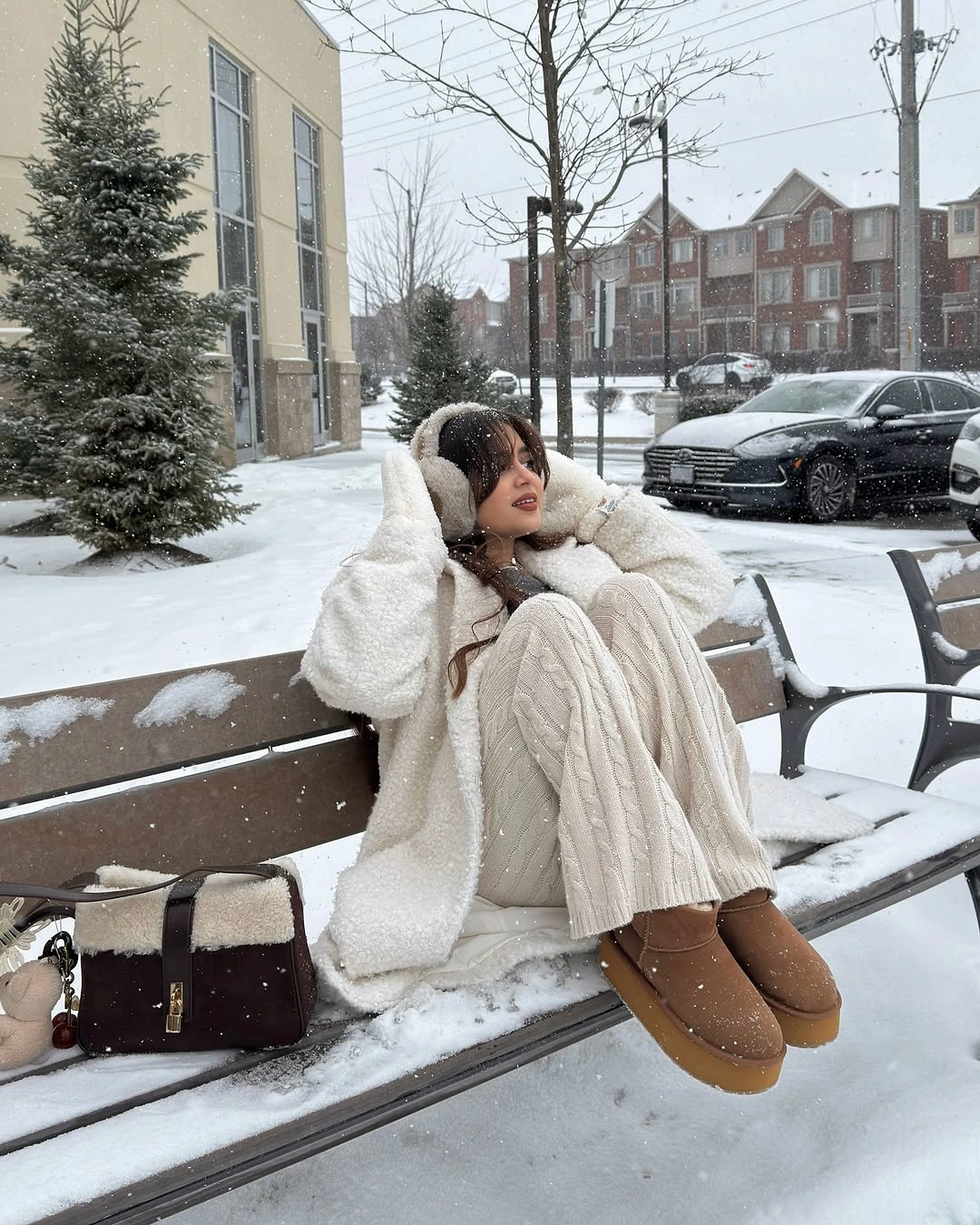 Off-white hooded coat with cable-knit pants and brown boots
