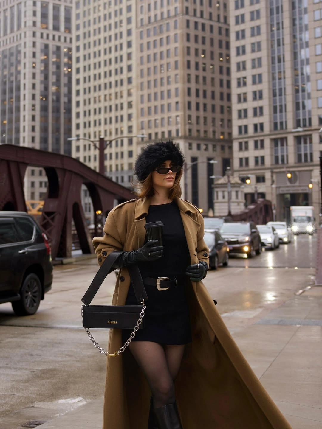 Camel coat over black base with tights, boots and fuzzy hat
