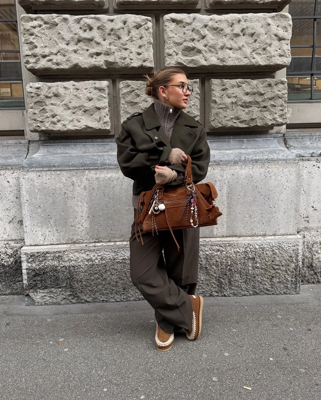 Cropped olive jacket with slouchy trousers and embellished brown bag