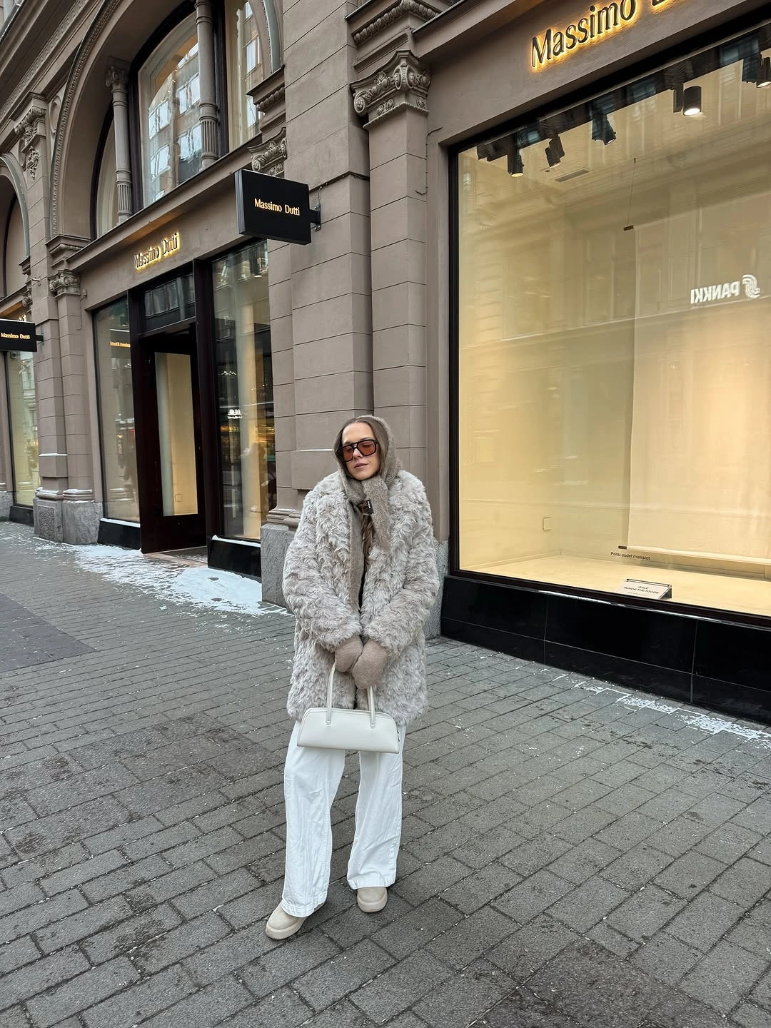 Gray fur-like jacket with white pants handbag and light footwear