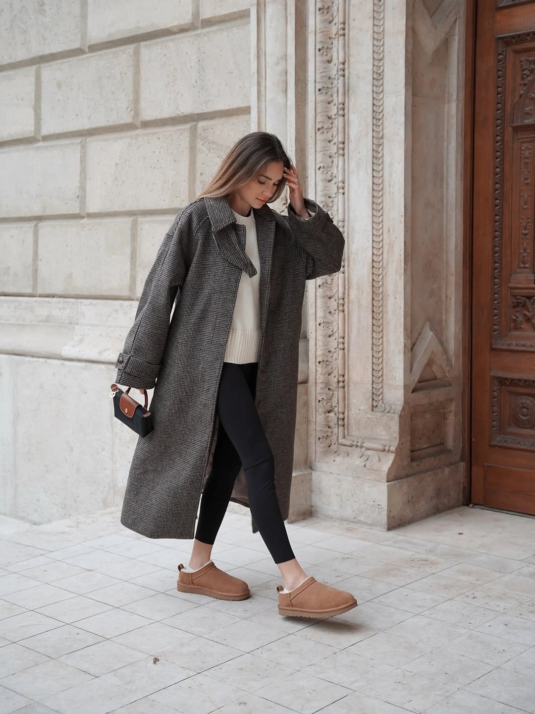 Long gray coat with cream sweater cropped black pants and tan shoes