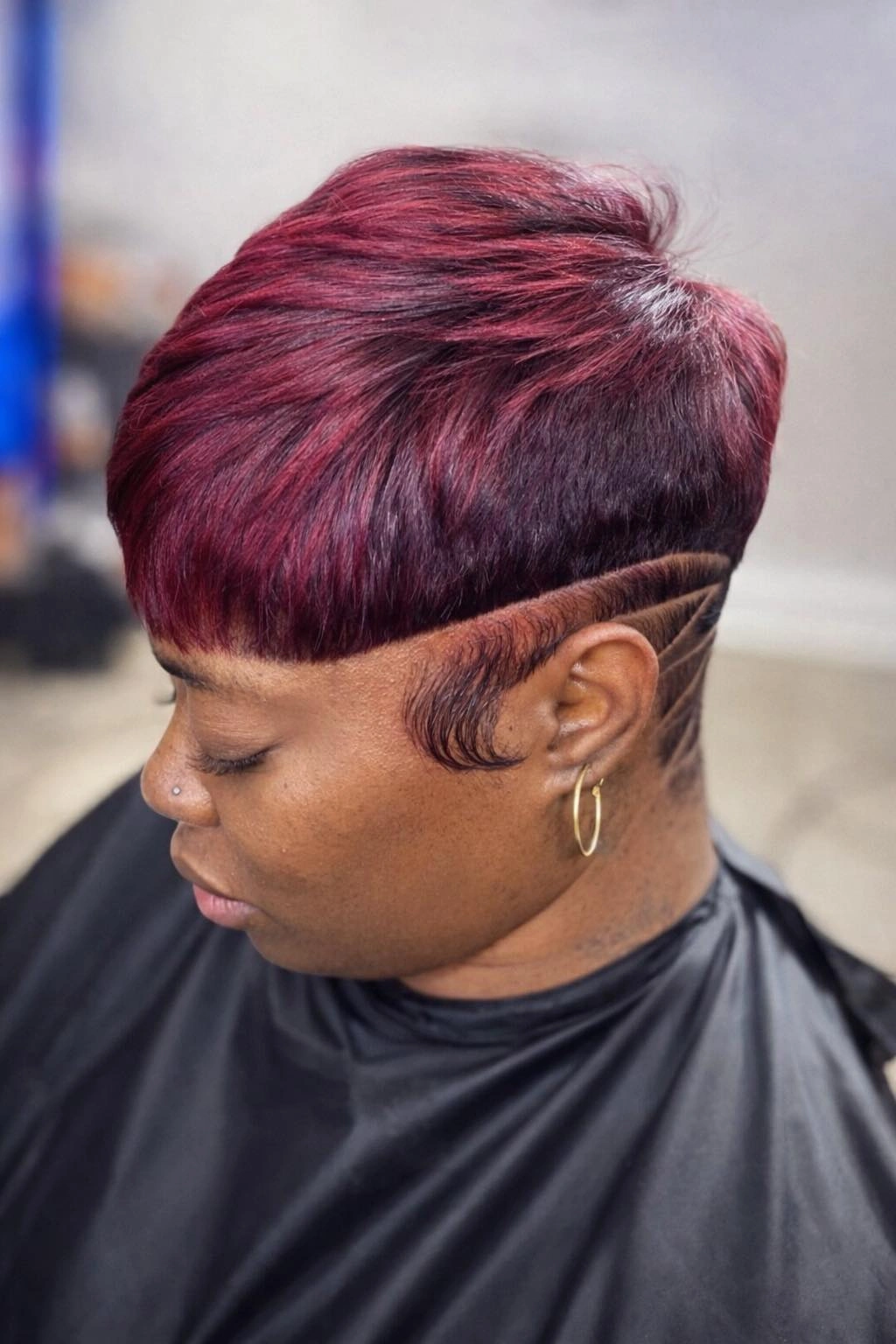 Black updo with curled top loops and side-swept front hair