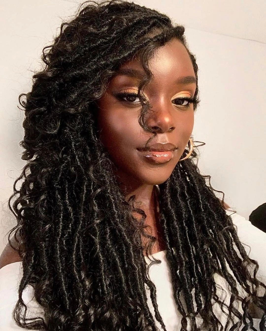 Near-black coily high puff with lifted volume and compact sides