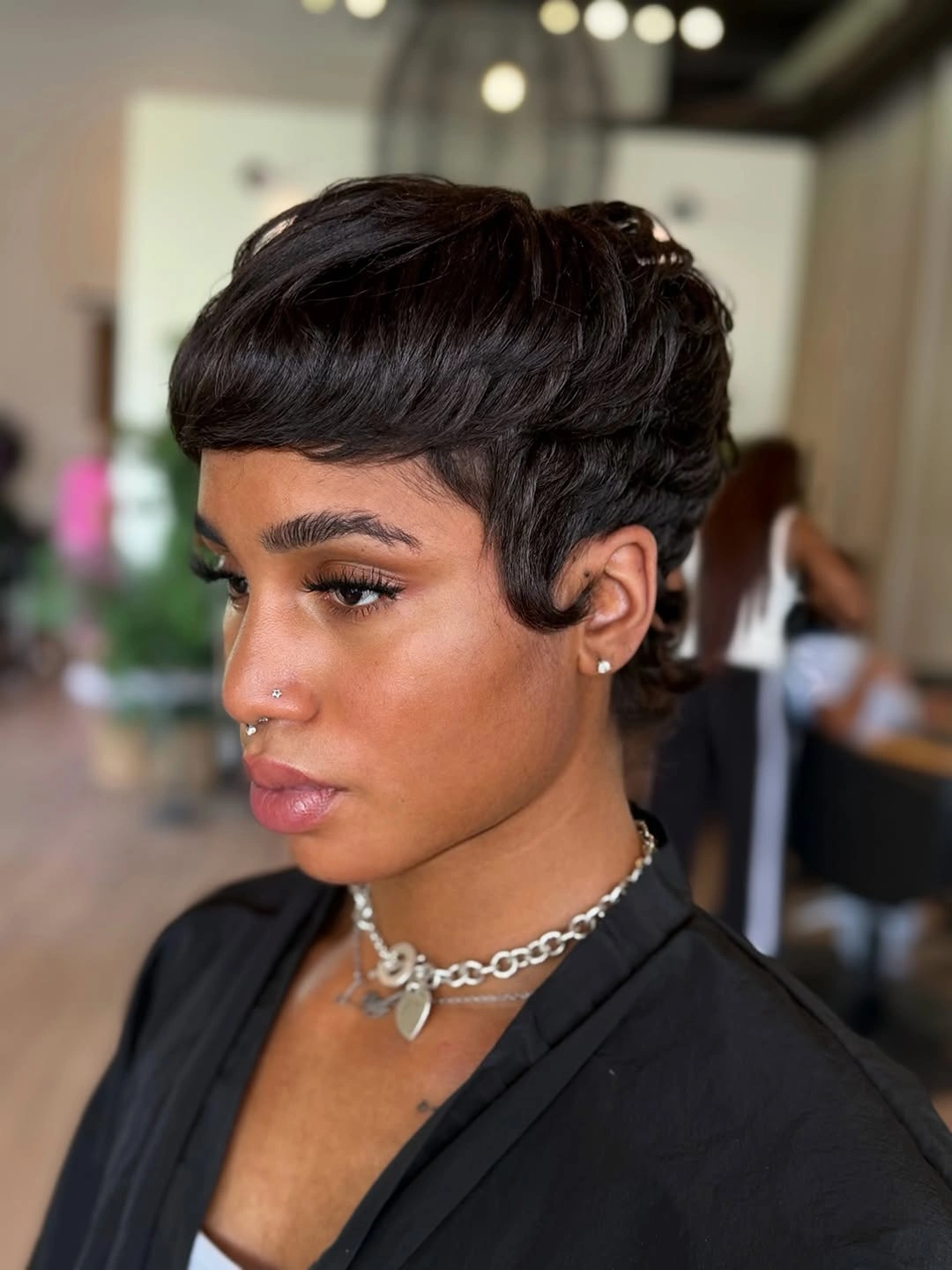 Sleek black center-part bob with smooth panels and blunt ends