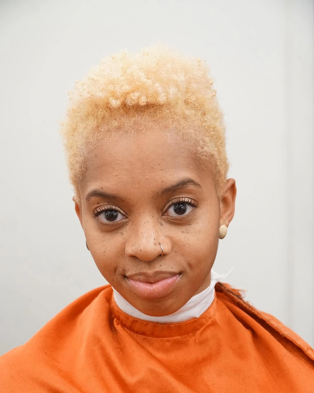 Short copper-auburn side-swept hair with darker cropped sides