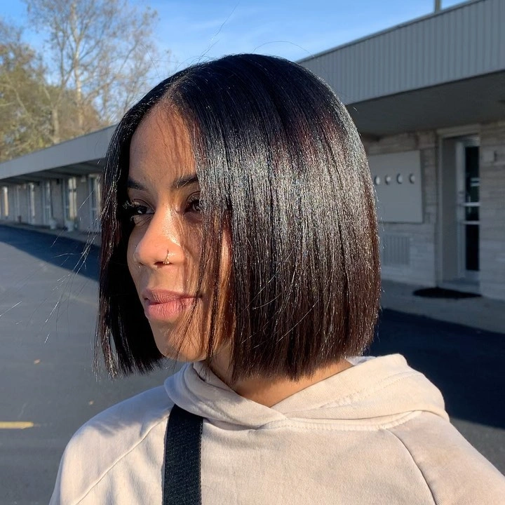 Dark center-parted curls with two high curl clusters