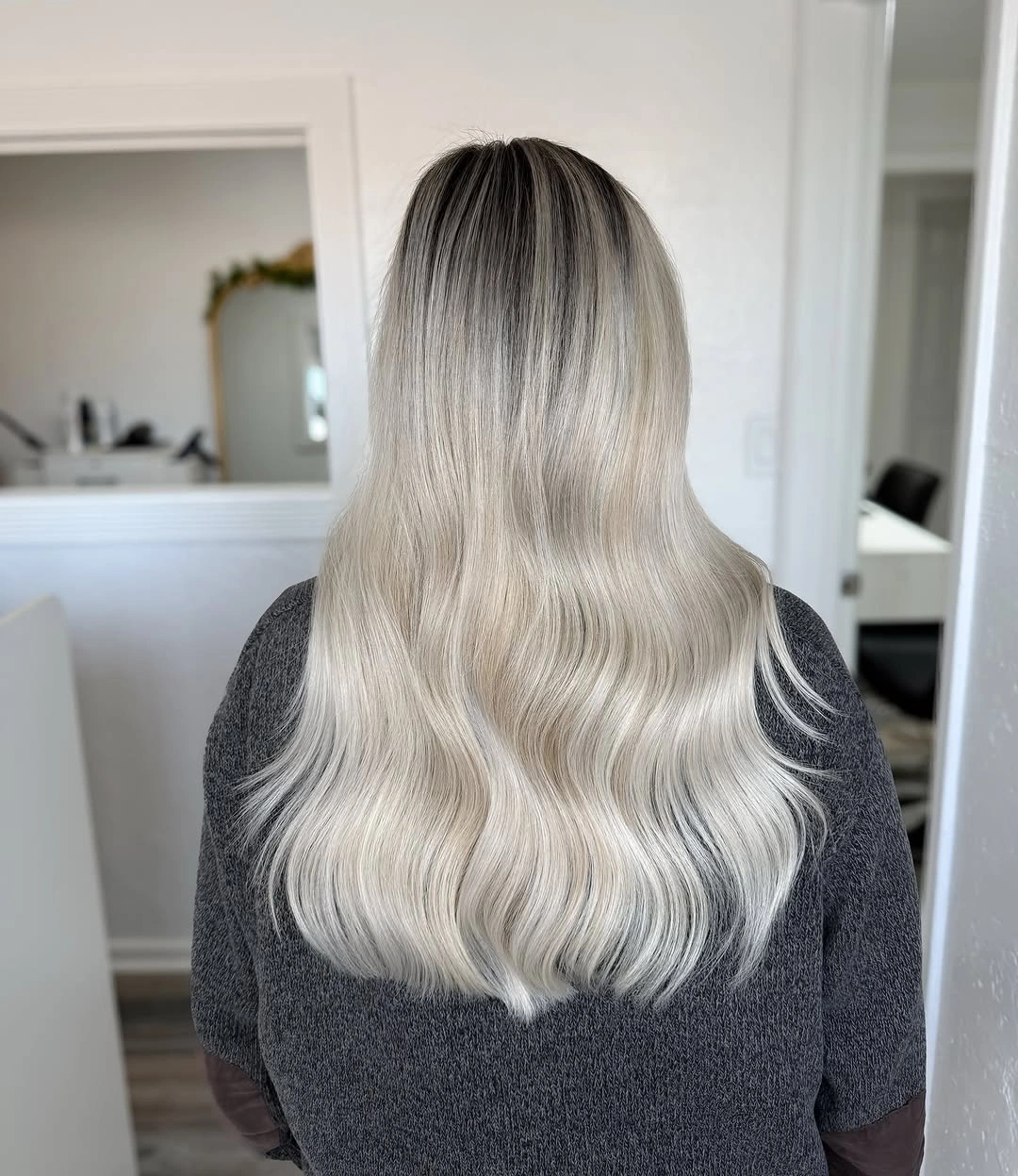 Long icy blonde waves with darker root area