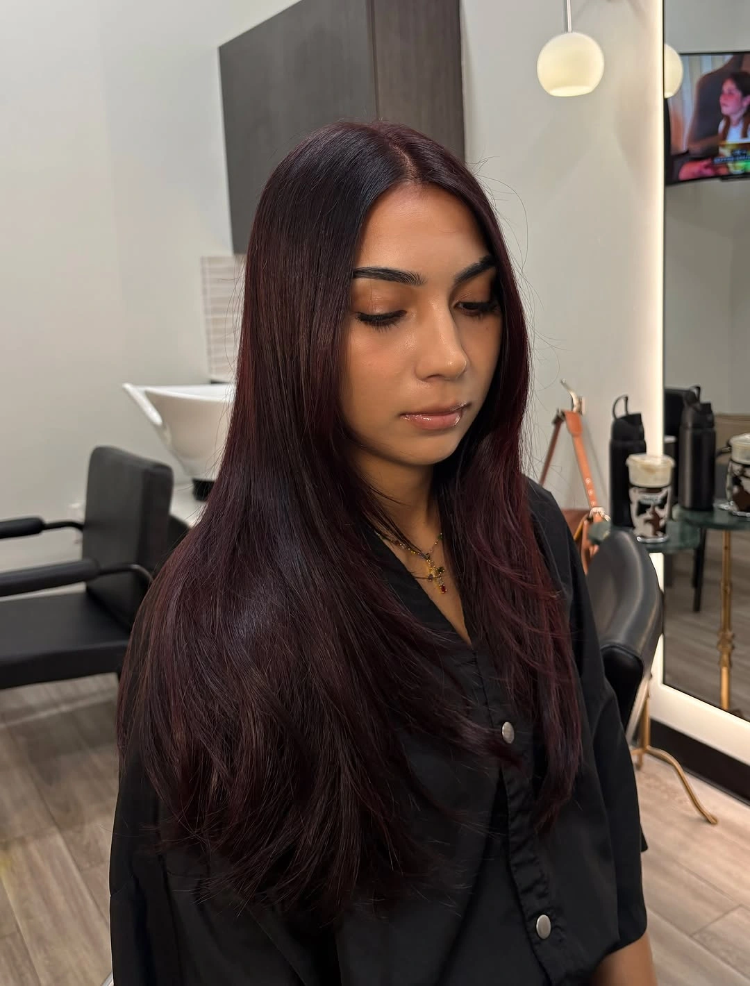 Long straight dark plum-brown hair with center part