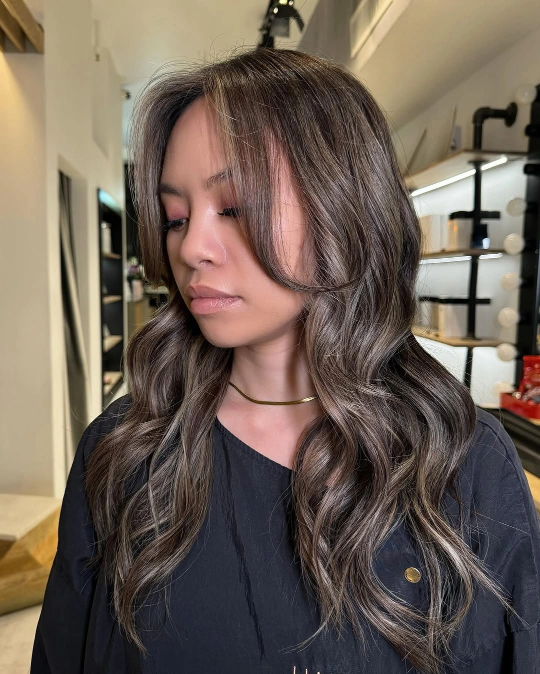 Long brunette waves with cool taupe face-framing ribbons