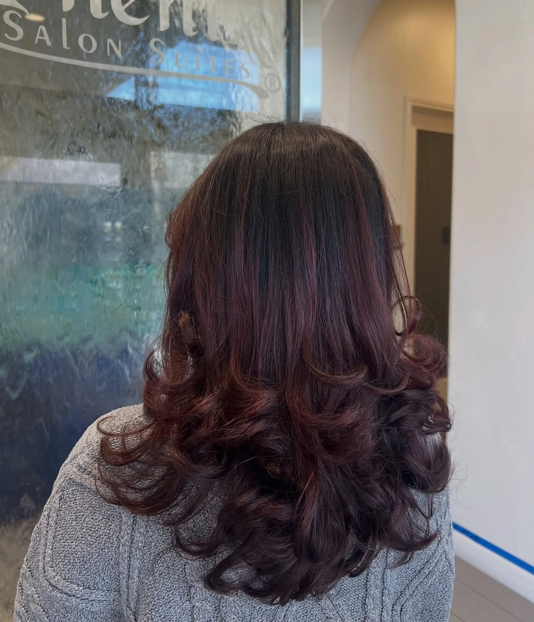 Dark brunette layered hair with red-brown curled lower ribbons