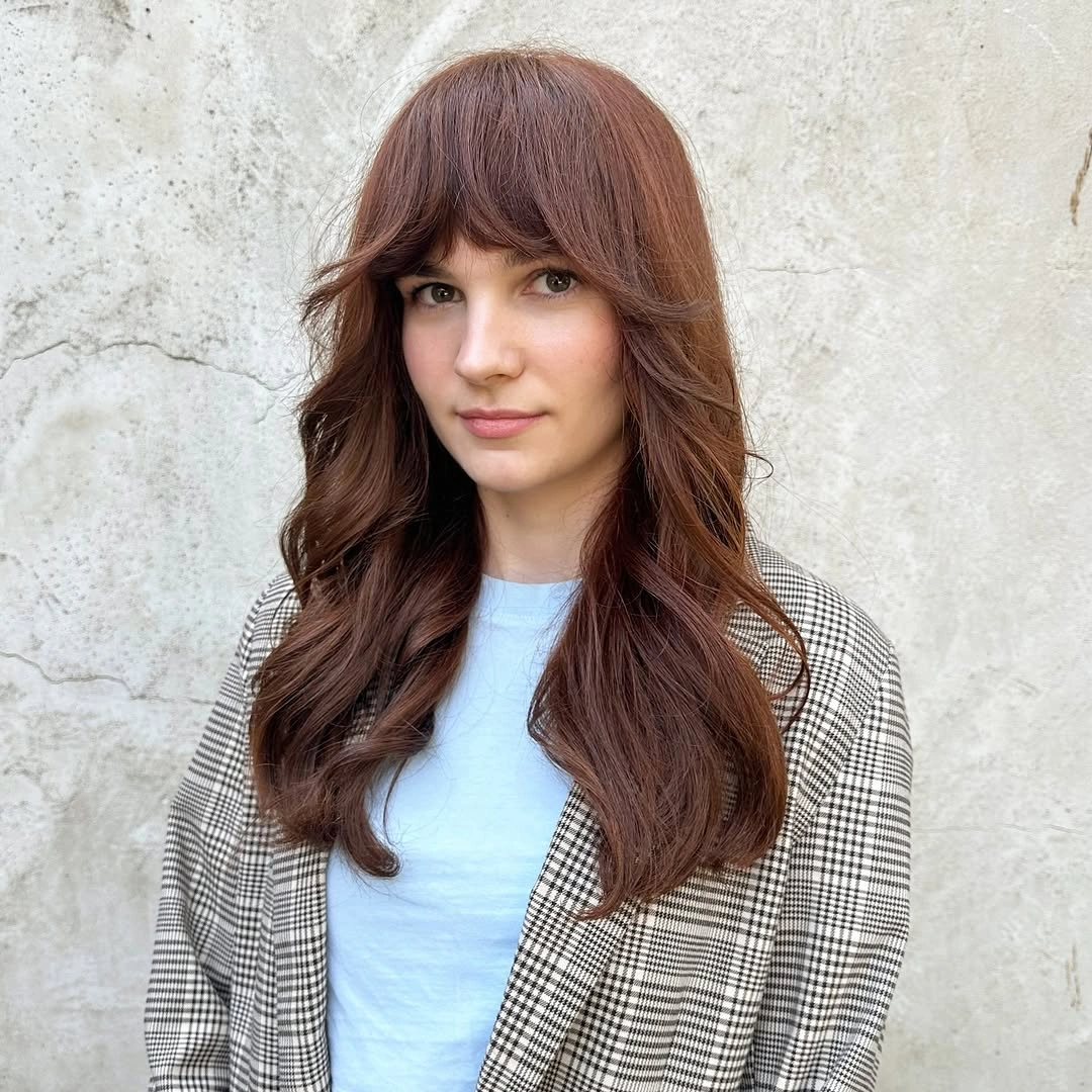 Long auburn-brown waves with full soft fringe