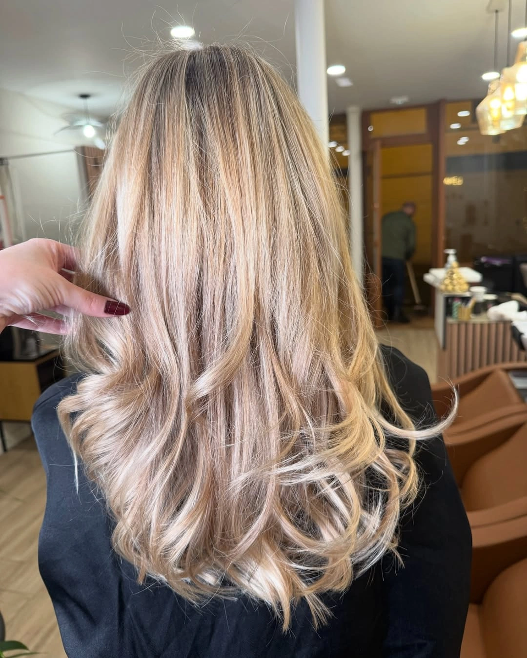 Long blonde hair with blended pale ribbons and curled ends