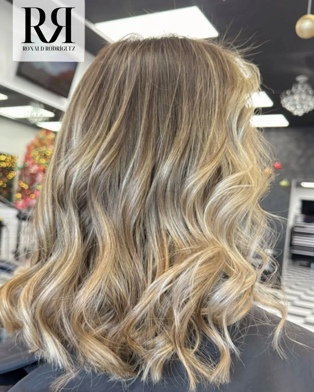 Medium-long blonde hair with loose waves and softly layered ends