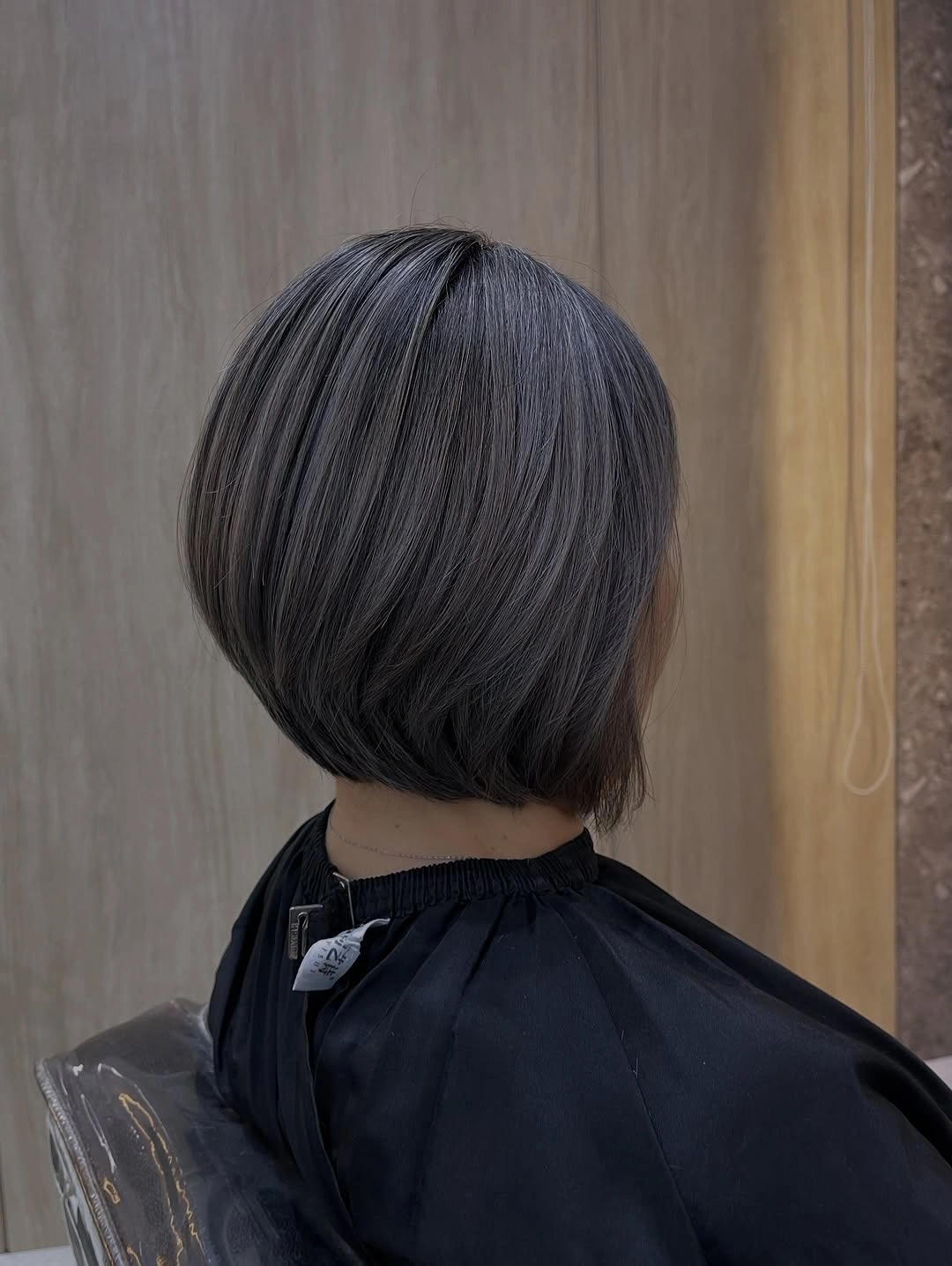 Back view of short rounded dark bob with exposed nape
