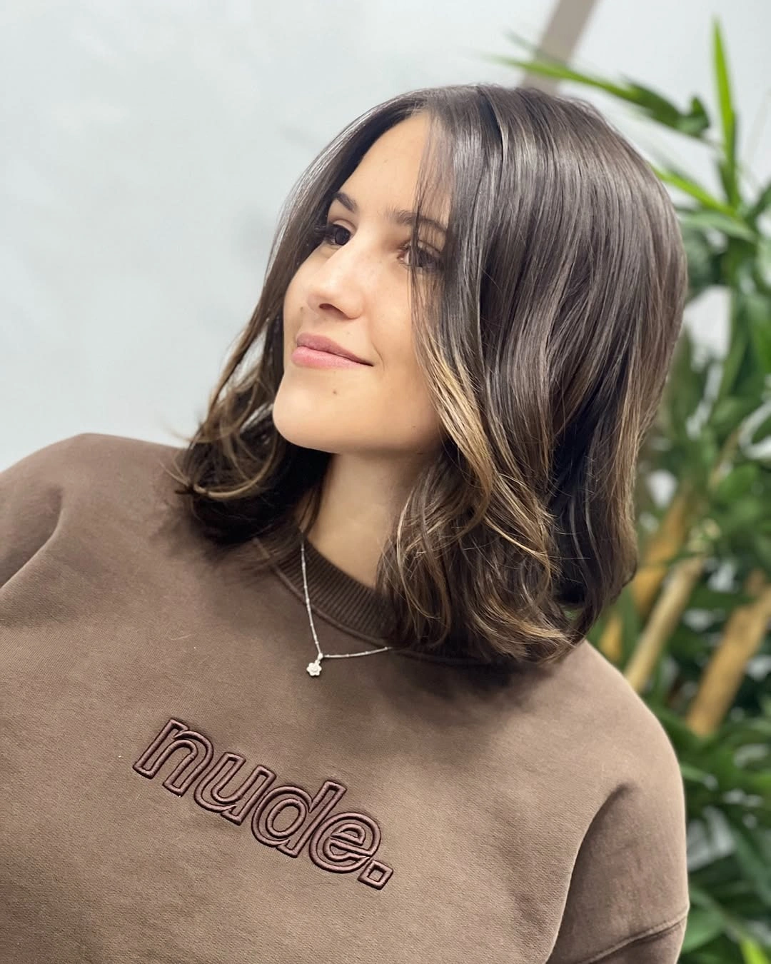 Shoulder-length dark lob with center part and soft front layers