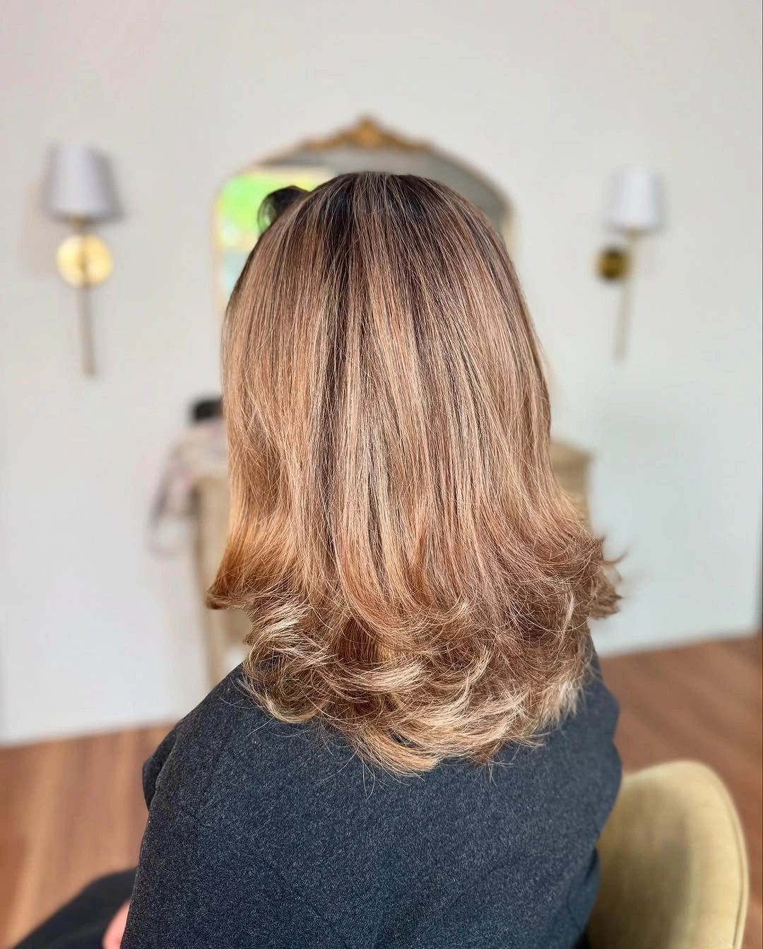 Medium layered brown hair with smooth crown and flipped-out ends