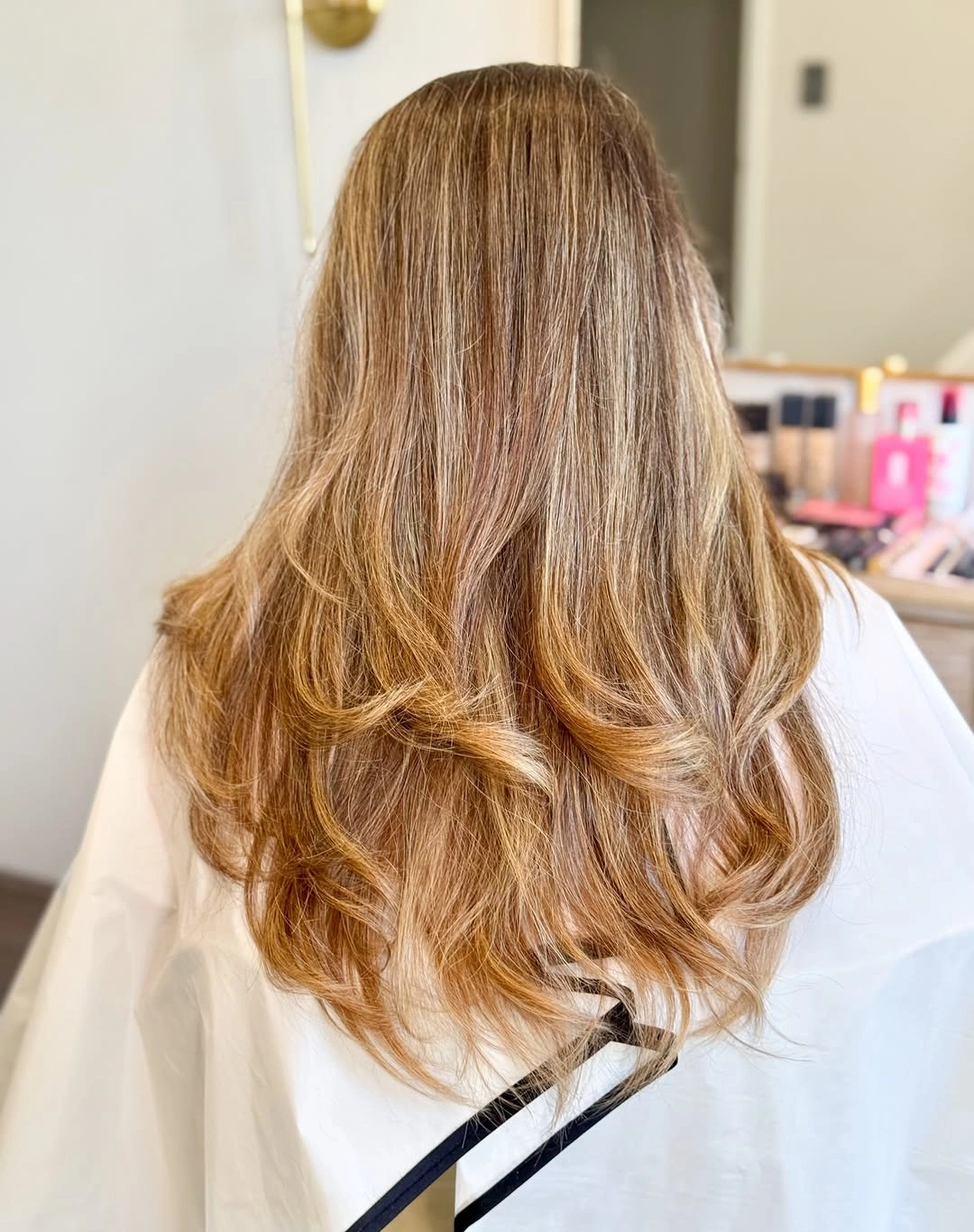 Long light brown hair with gradual layers and softly curled ends