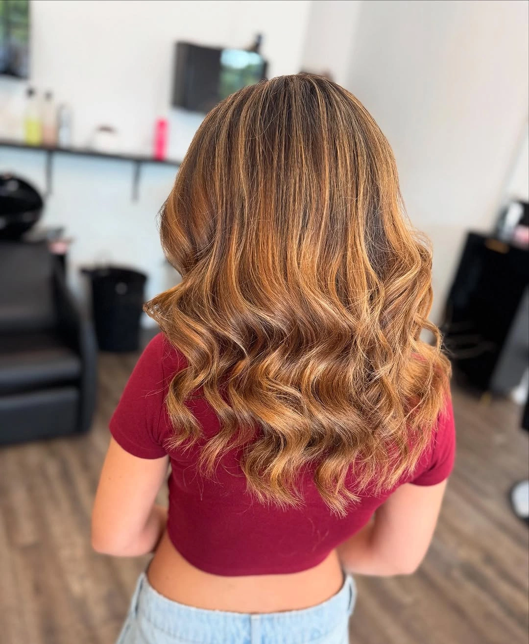 Long highlighted hair with defined curls through lower lengths