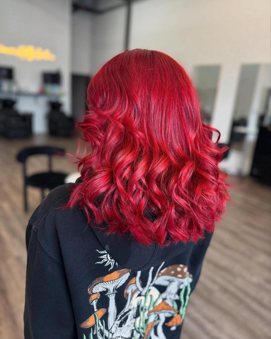 Bright red shoulder-length hair with defined lower curls