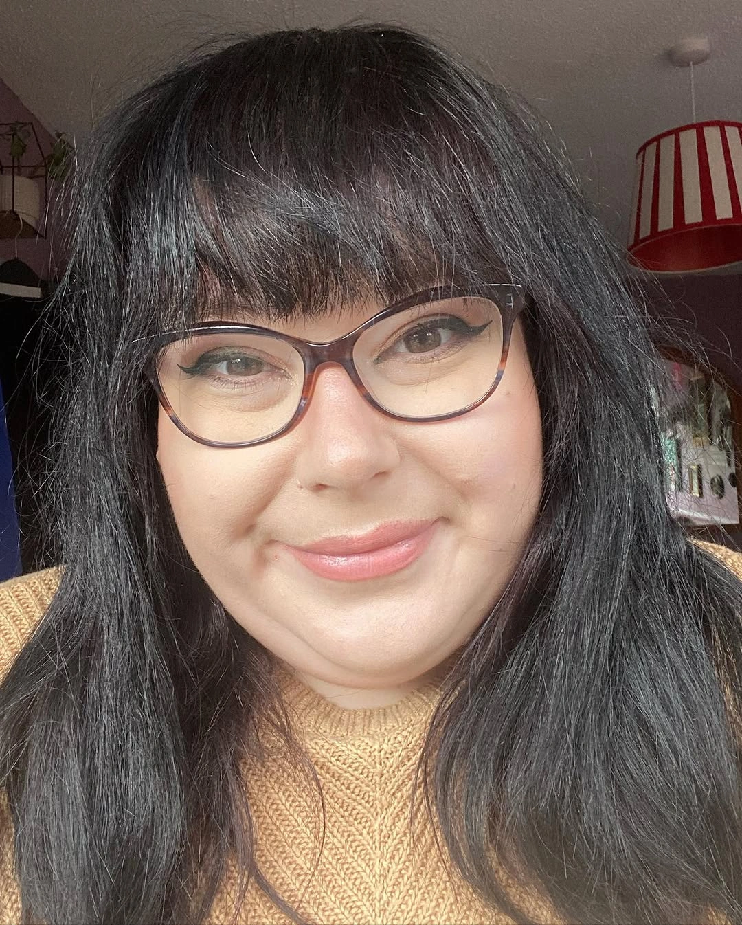Long straight dark hair with blunt fringe and glasses