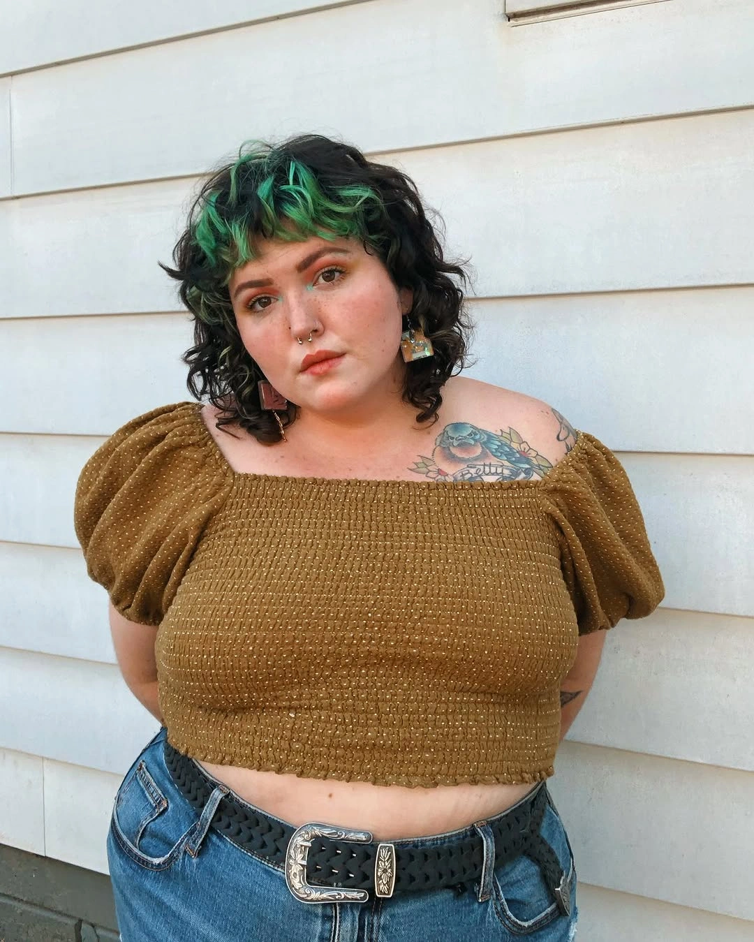 Short dark curly hair with green front sections and longer nape