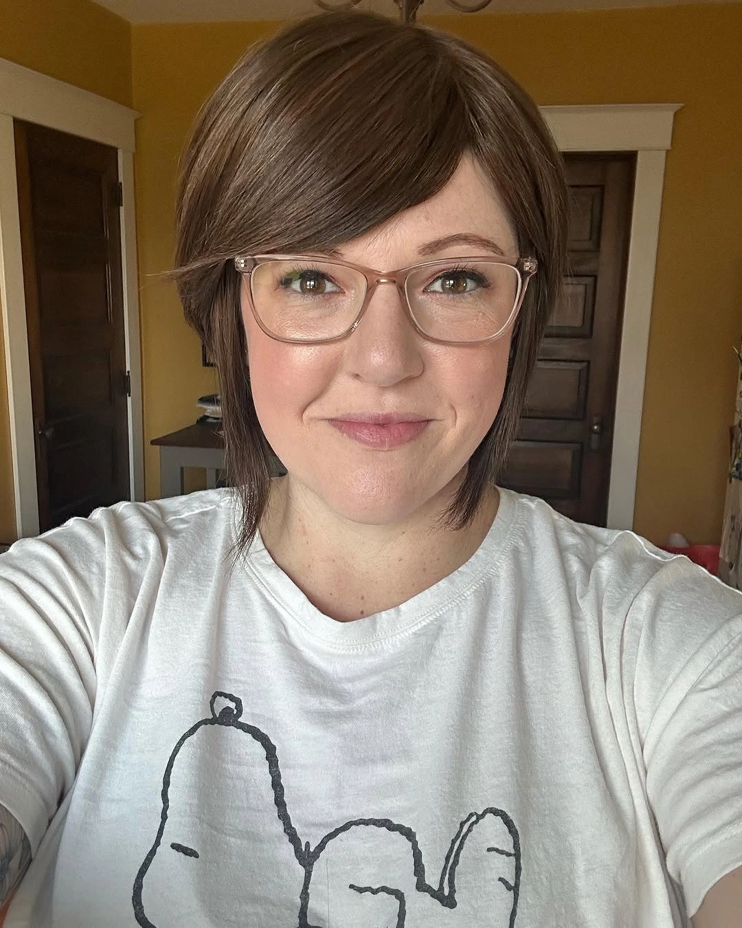 Short brown side-swept bob with glasses and neat nape