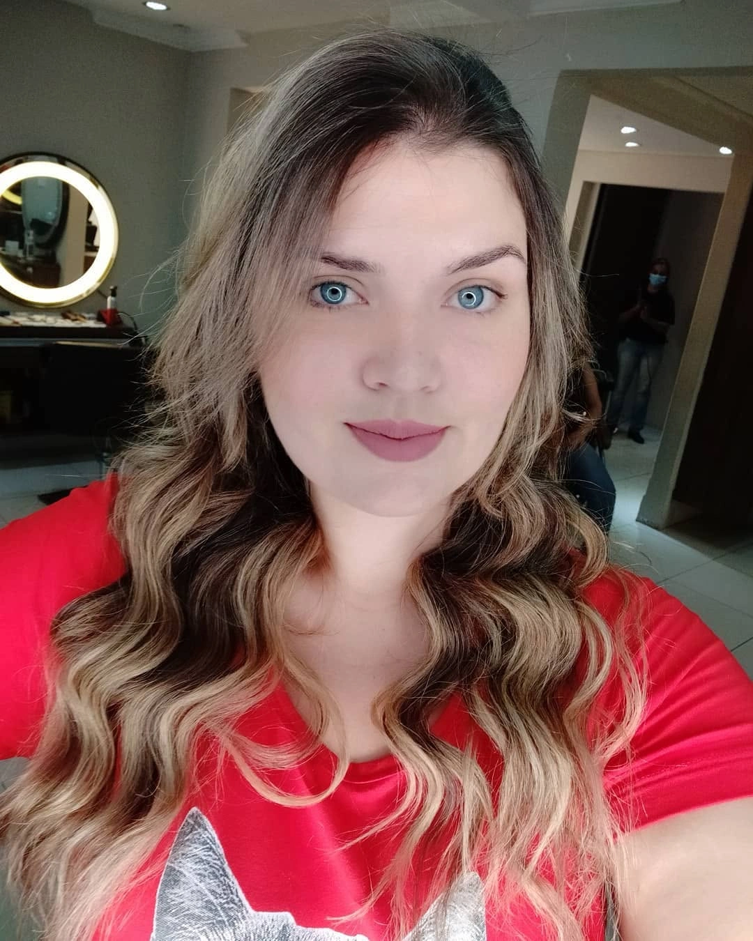 Long dark-to-blonde hair with loose waves and off-center part