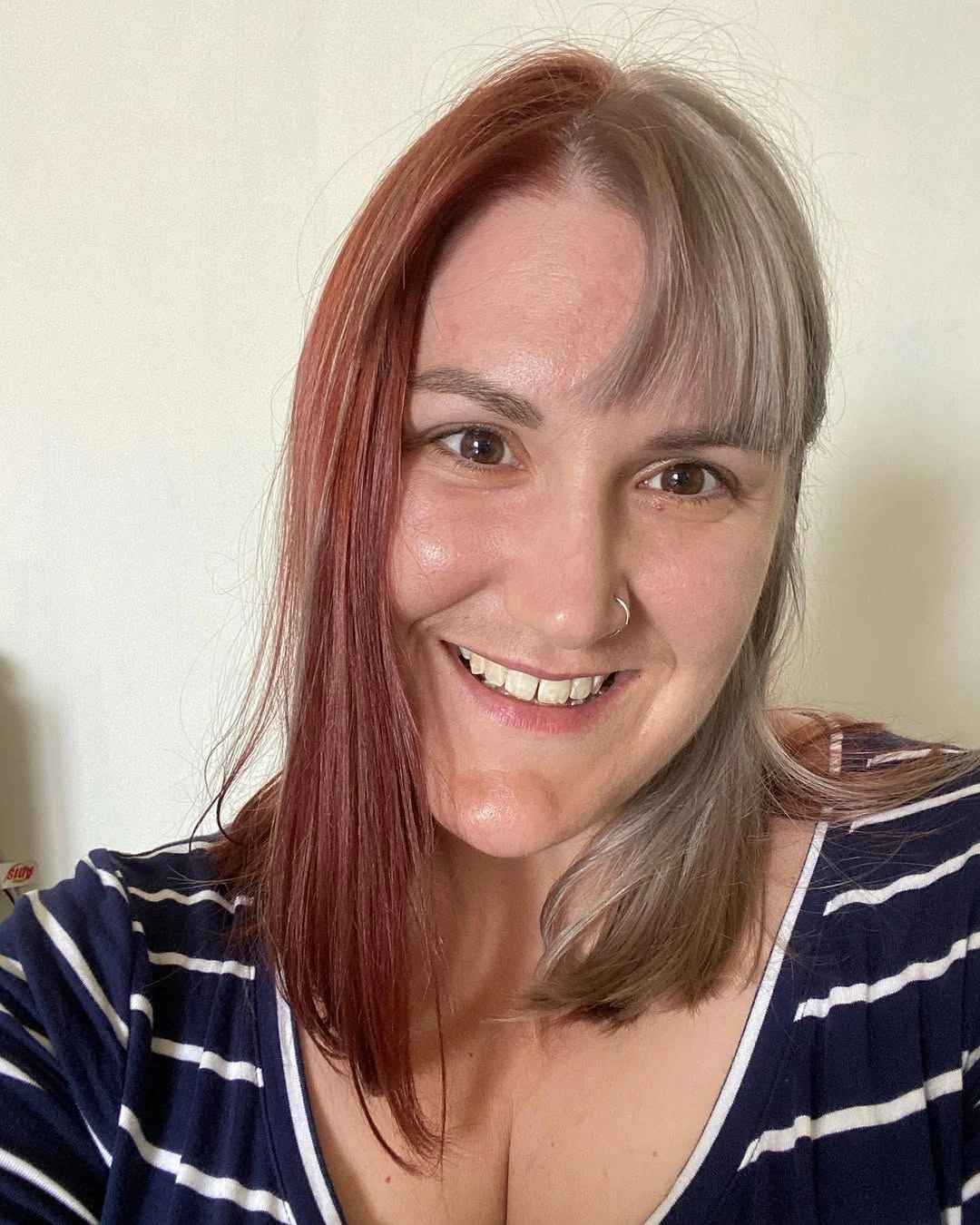 Straight shoulder-length hair split between red and pale gray