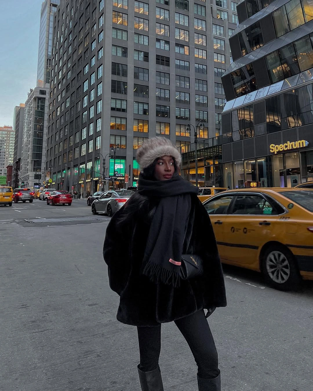 Black plush coat with wide scarf and gray textured hat