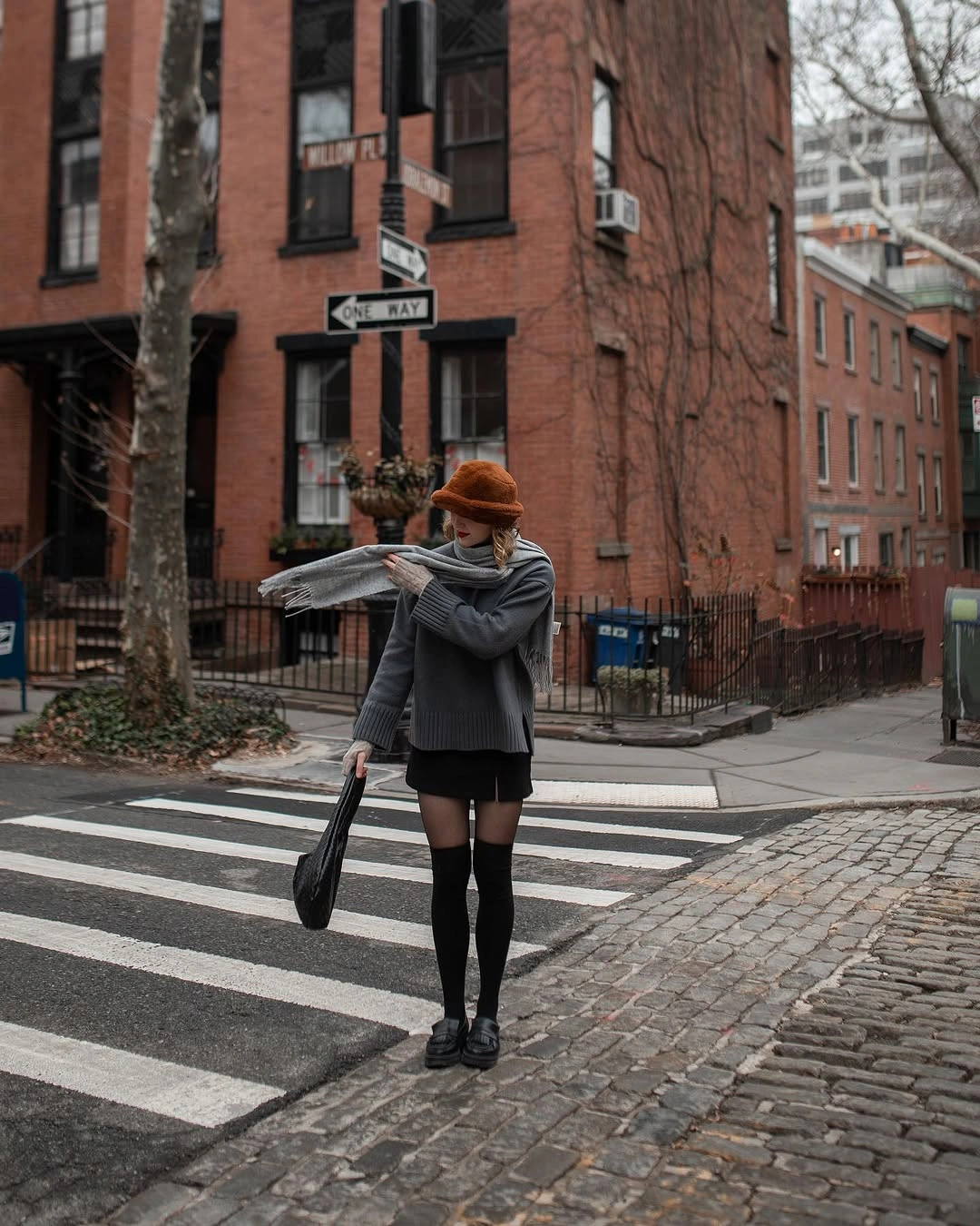 Gray oversized sweater with black shorts and tall socks