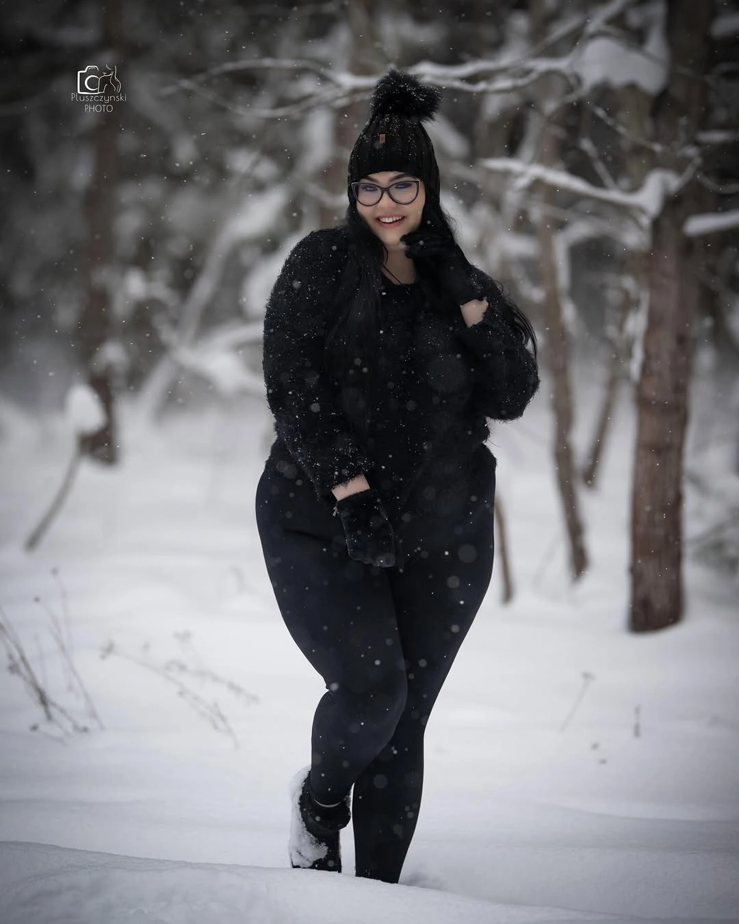 Black beanie, fuzzy jacket, pants, and boots in snow
