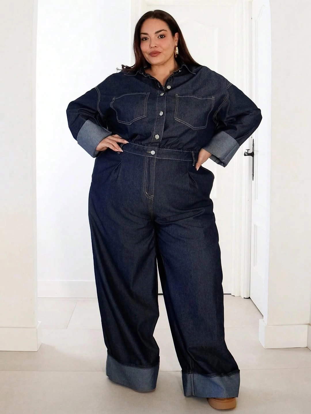 Dark denim jumpsuit with rolled sleeves and wide cuffs